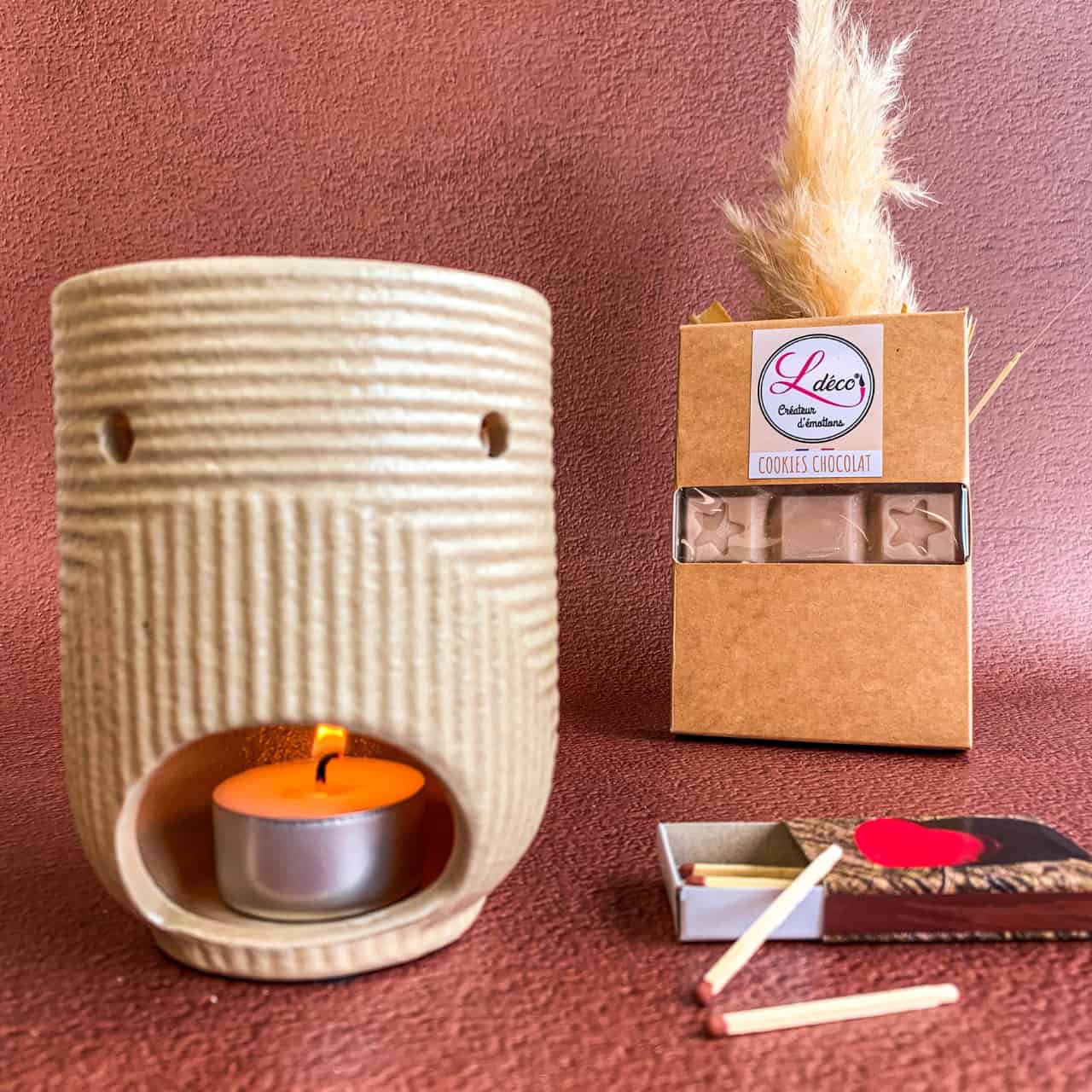Cire parfumée artisanale naturelle Ldéco en fusion dans la coupelle d'un brûleur allumé avec bougie chauffe plat, fondant cire végétale diffusion parfum Grasse ambiance bien-être Made in France Vosges